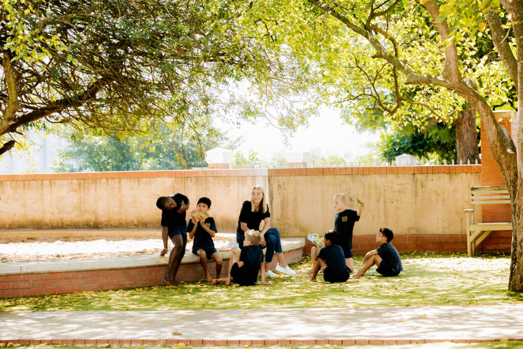 Primary School boys sitting in their garden during an outdoor lesson