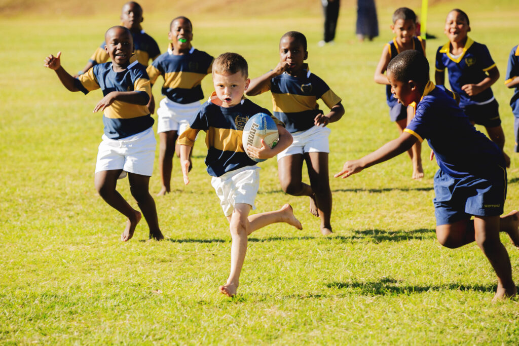 Junior Primary School boys playing in a mini rugby match