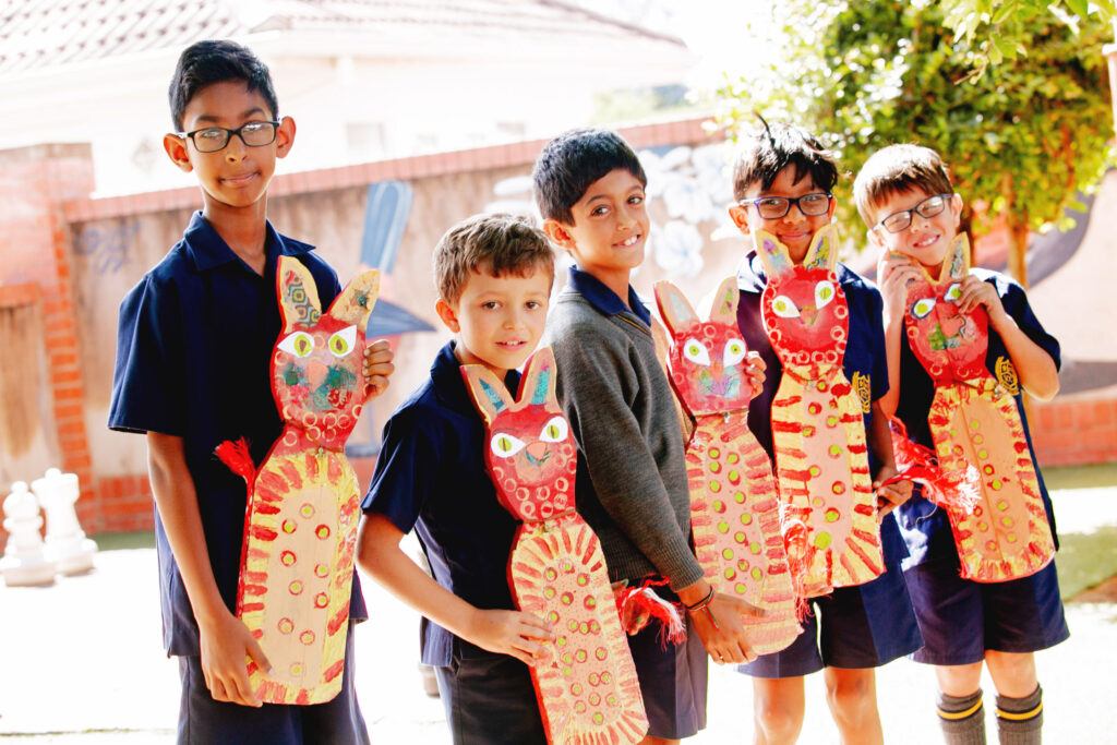 Junior Primary boys showing the art that they have created